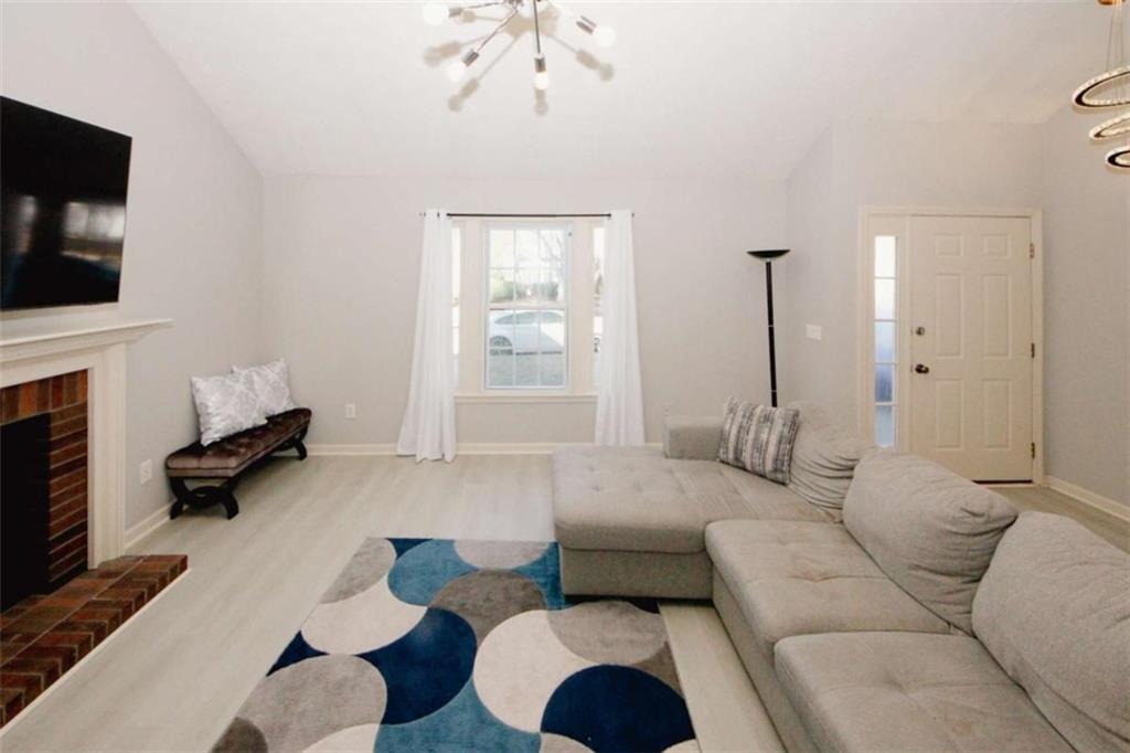 4025 Ivy Run Circle Duluth, GA 30096 - Photo 6 of 34 a living room with furniture and a flat screen tv