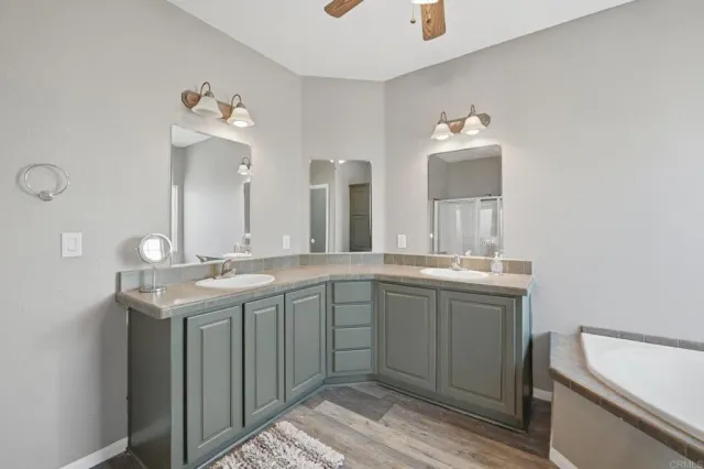 a spacious bathroom with a granite countertop sink and a mirror