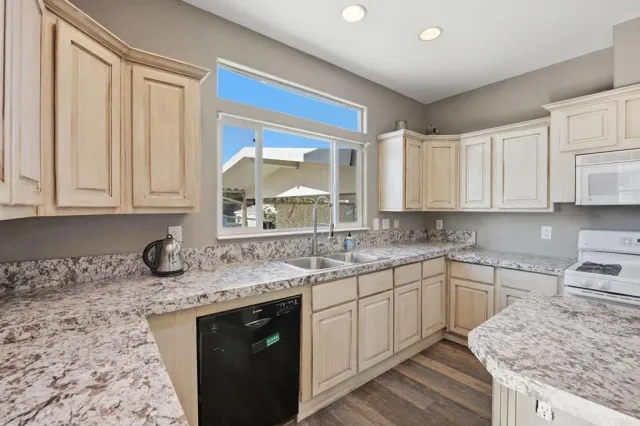 a kitchen with stainless steel appliances granite countertop a sink stove and cabinets