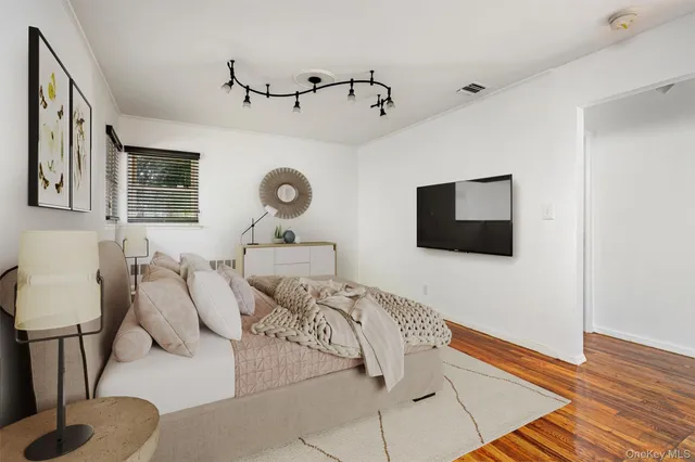 a view of a room with wooden floor and white walls