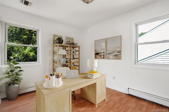 wooden floor in an empty room with a window