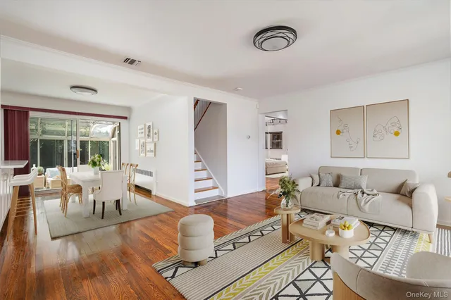 a living room with furniture and wooden floor