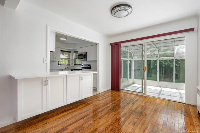 a view of a kitchen with a sink dishwasher and wooden floor