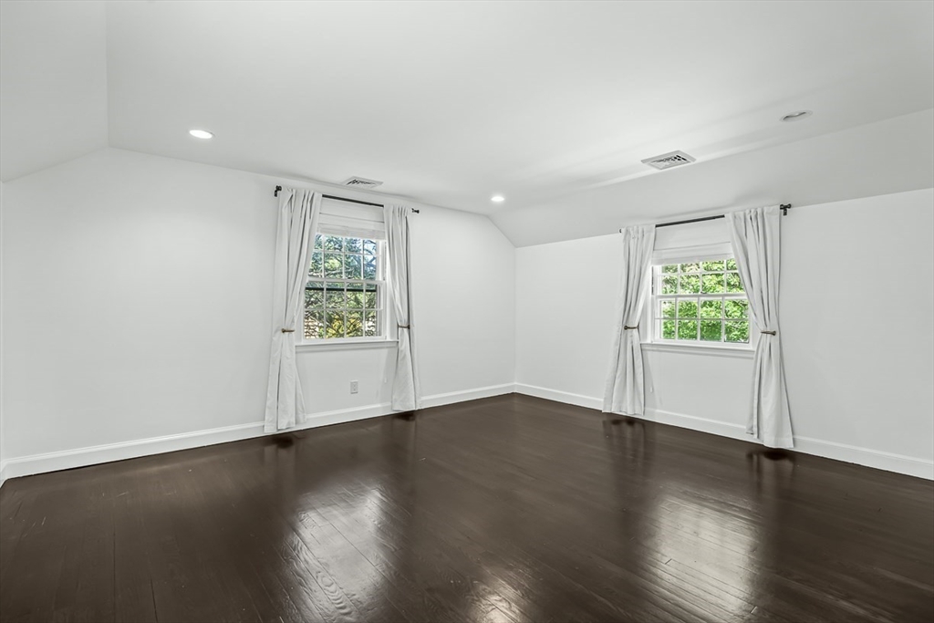 53 Madison Road Wellesley, MA 02481 - Photo 11 of 18 a view of an empty room with wooden floor and a window