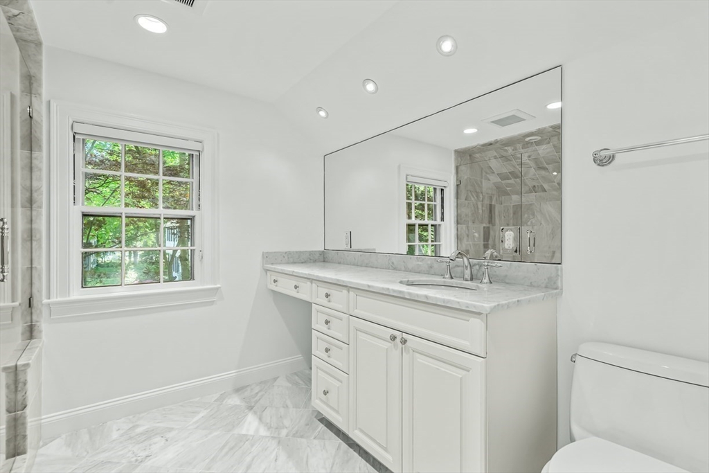 53 Madison Road Wellesley, MA 02481 - Photo 12 of 18 a bathroom with a granite countertop sink a toilet a mirror and a window