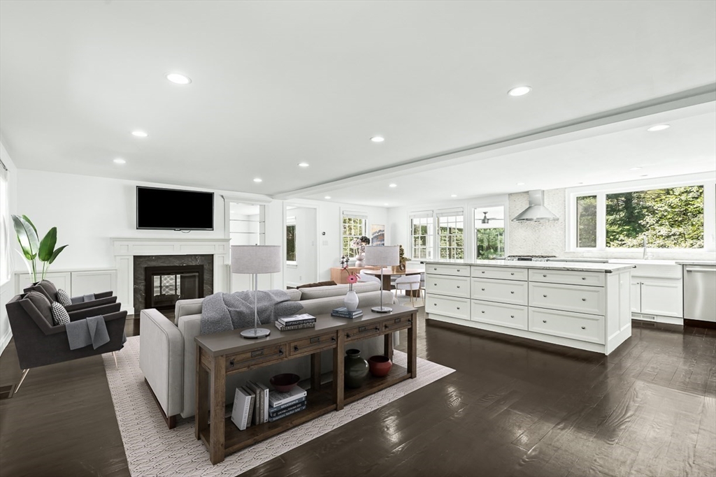 53 Madison Road Wellesley, MA 02481 - Photo 3 of 18 a kitchen with stainless steel appliances kitchen island granite countertop a stove and a fireplace