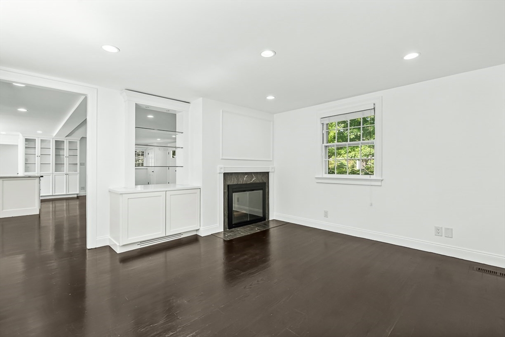53 Madison Road Wellesley, MA 02481 - Photo 7 of 18 an empty room with wooden floor and windows