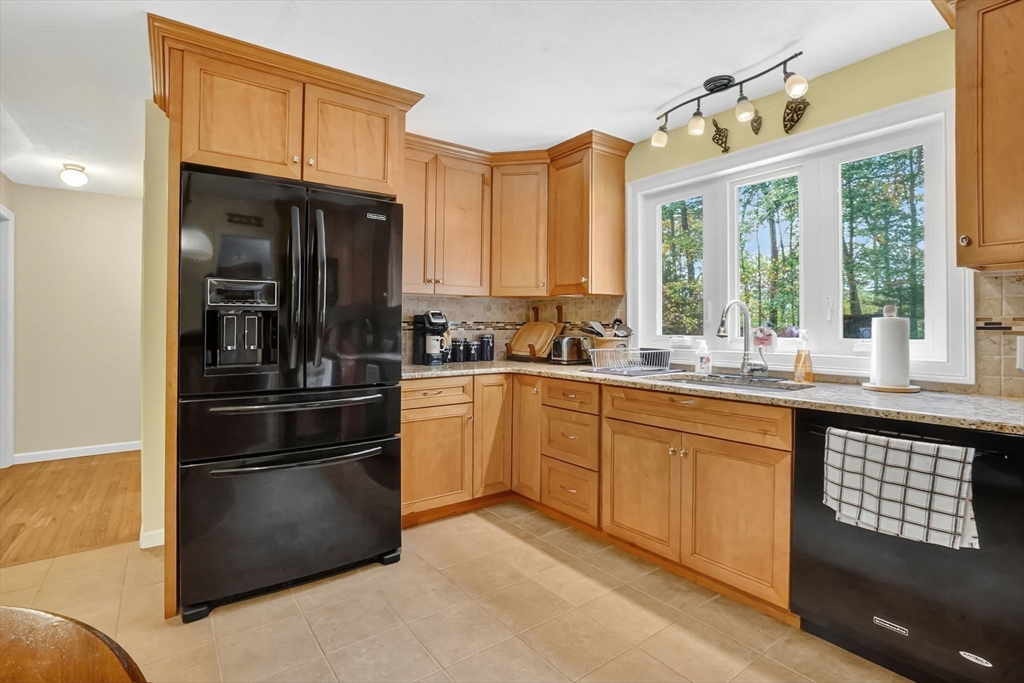56 Reservoir Road Westhampton, MA 01027 - Photo 7 of 42 a kitchen with granite countertop stainless steel appliances a sink cabinets and a window