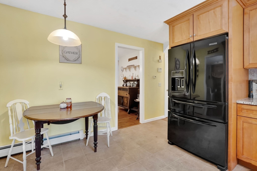 56 Reservoir Road Westhampton, MA 01027 - Photo 8 of 42 a kitchen with a refrigerator a sink and dining table