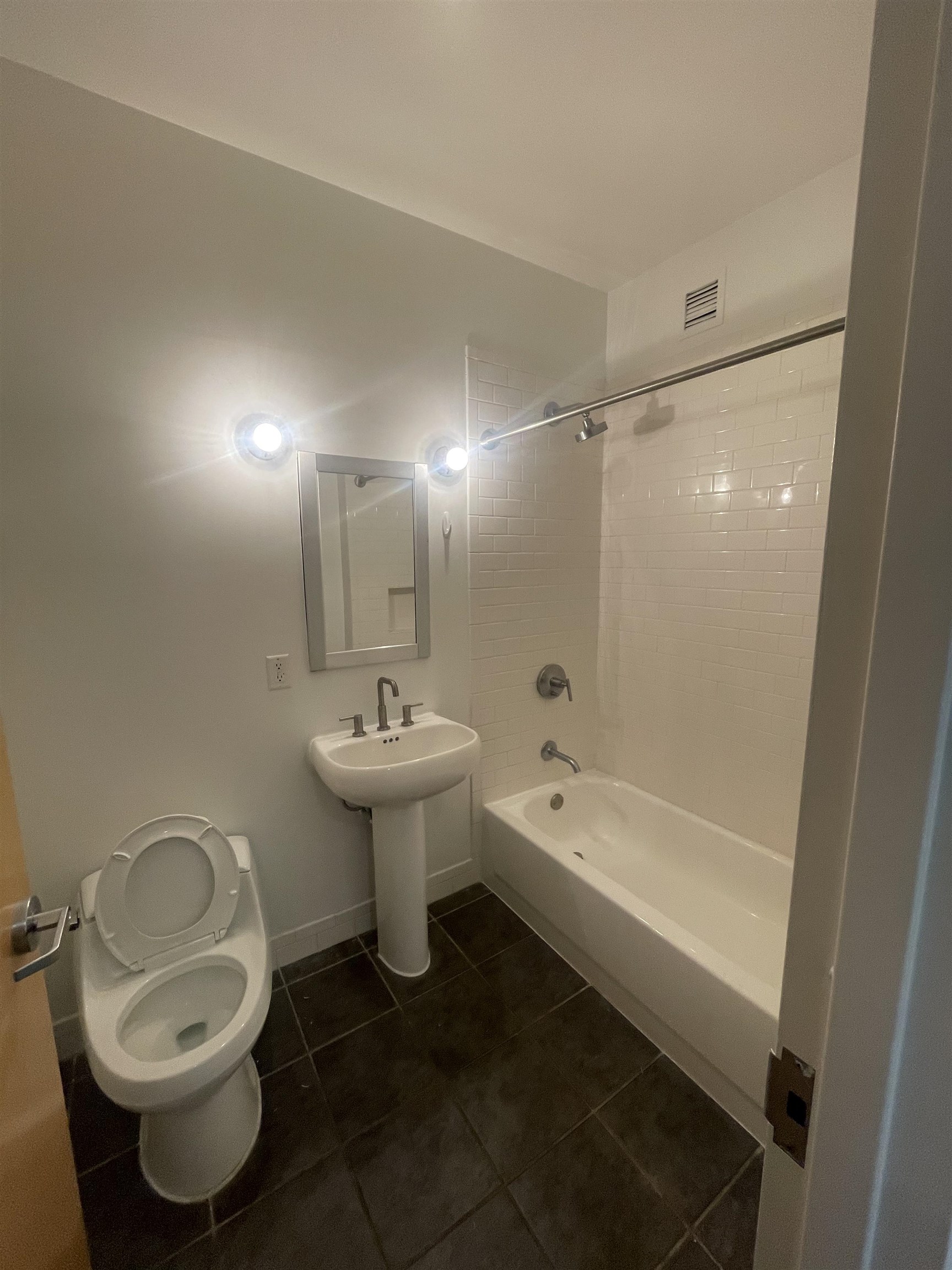 150 Bay Street, Unit 911 Jersey City, NJ 07302 - Photo 7 of 14 a bathroom with a sink toilet and shower
