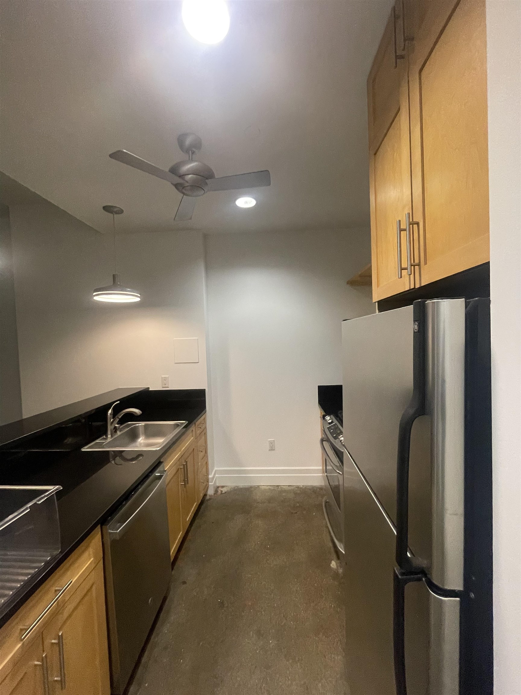 150 Bay Street, Unit 911 Jersey City, NJ 07302 - Photo 8 of 14 a kitchen with a sink a refrigerator and cabinets