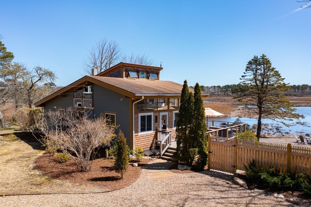 97 Bells Neck Road West Harwich, MA 02671 - Photo 1 of 41 a front view of a house with garden