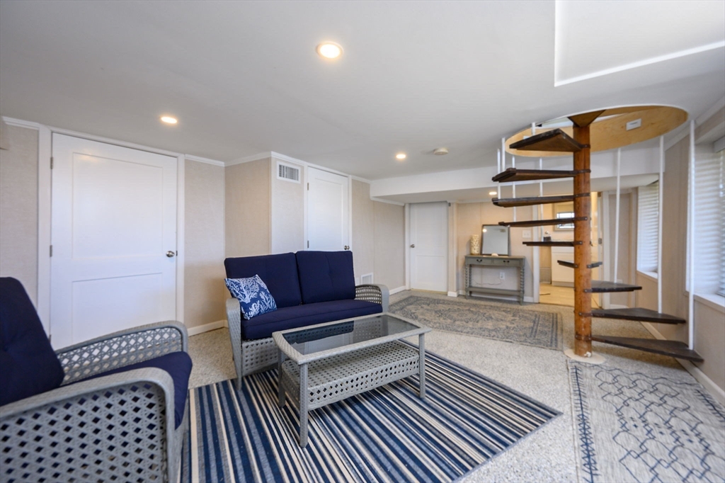 97 Bells Neck Road West Harwich, MA 02671 - Photo 21 of 41 a living room with furniture and a rug