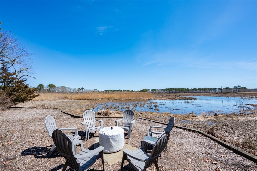 97 Bells Neck Road West Harwich, MA 02671 - Photo 28 of 41 a view of a lake with table and chairs