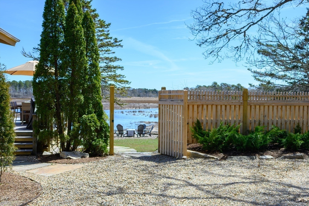 97 Bells Neck Road West Harwich, MA 02671 - Photo 5 of 41 a view of a garden with a bench