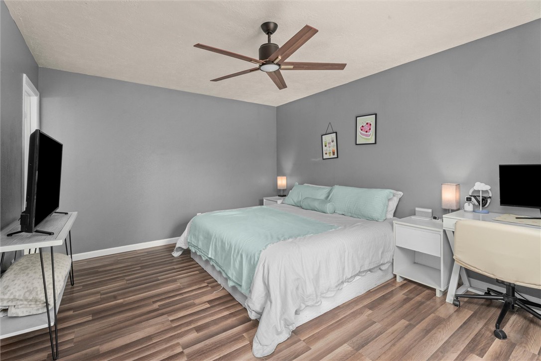 3511 Pecos Court Bryan, TX 77801 - Photo 13 of 22 a bedroom with a bed and a flat screen tv