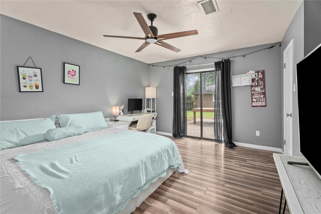 3511 Pecos Court Bryan, TX 77801 - Photo 14 of 22 a bedroom with a bed and a flat screen tv