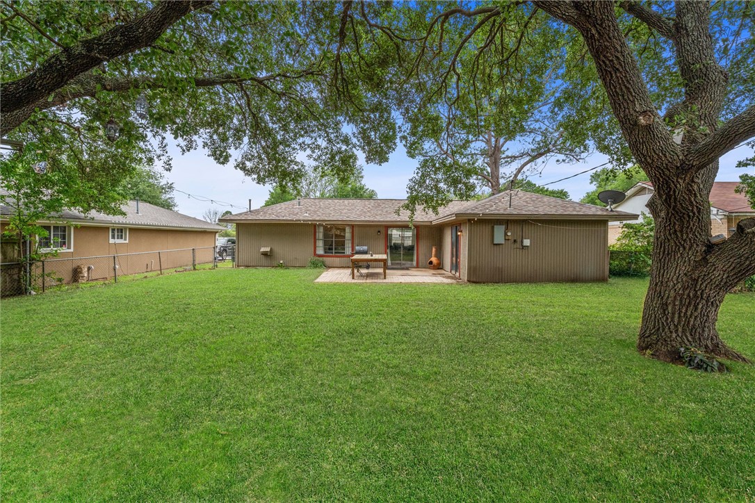 3511 Pecos Court Bryan, TX 77801 - Photo 20 of 22 a front view of a house with a garden and tree