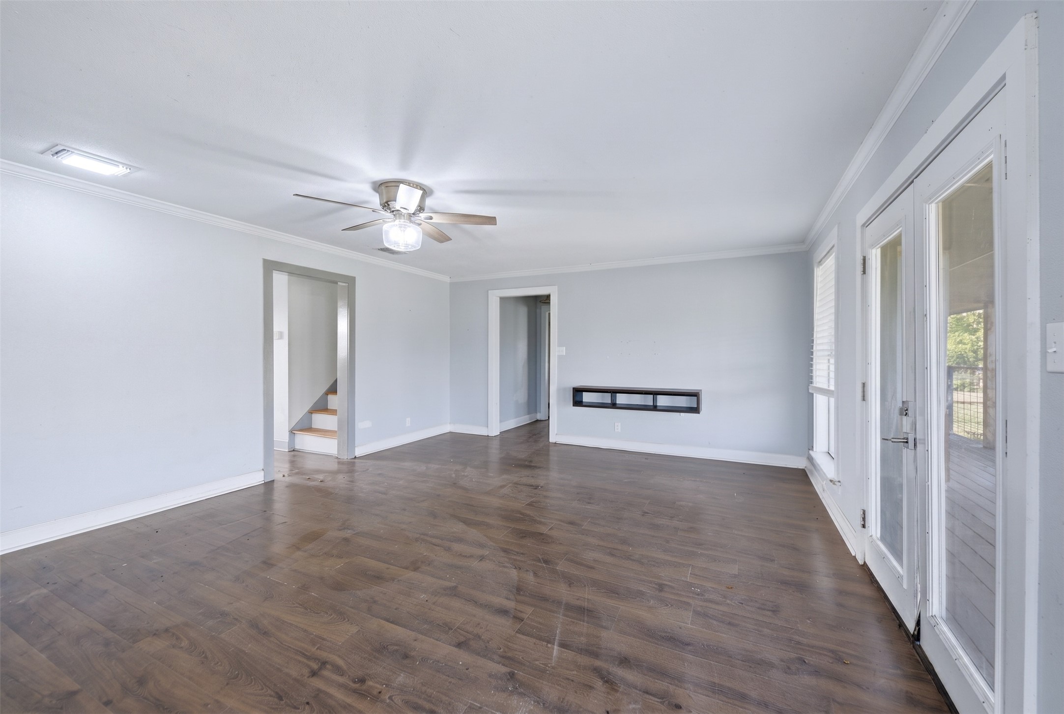2980 Rabbs Prairie Road La Grange, TX 78945 - Photo 16 of 28 Laminated wood floors extend throughout this ample living area, leading to double French doors and a clear view of the stairway.