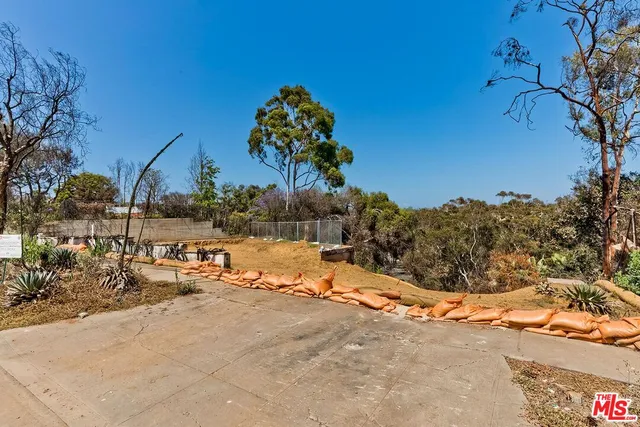 a view of a yard with snow on the road