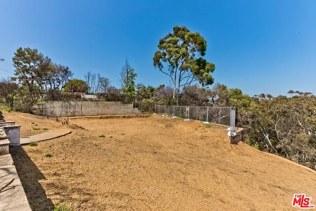 a view of a yard covered with snow in the background