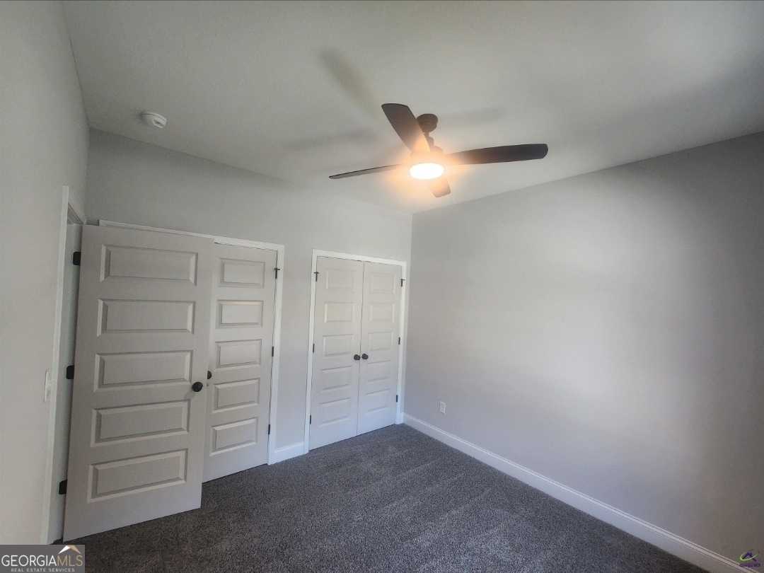 102 Silver Maple Court Byron, GA 31008 - Photo 2 of 17 an empty room with closet and a ceiling fan