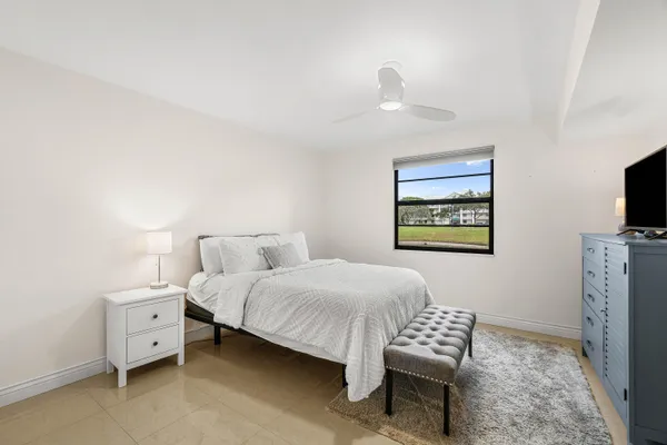 a bedroom with a bed and a tv