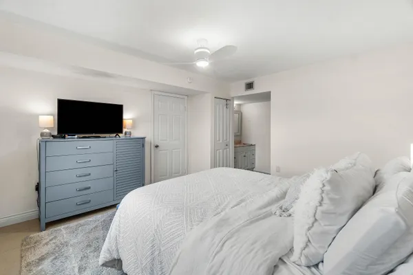 a large white bed in a white room