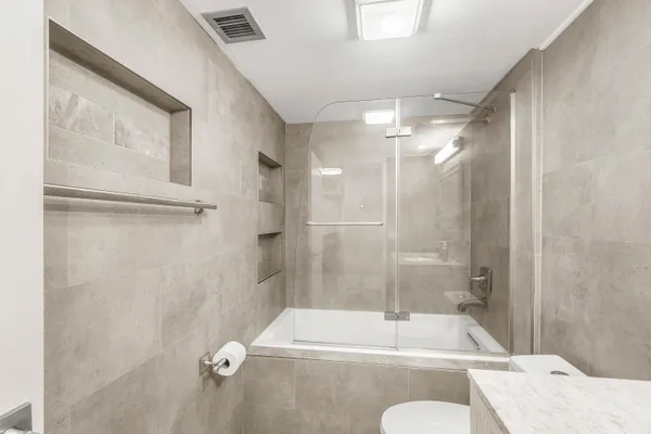 a bathroom with a sink toilet and shower