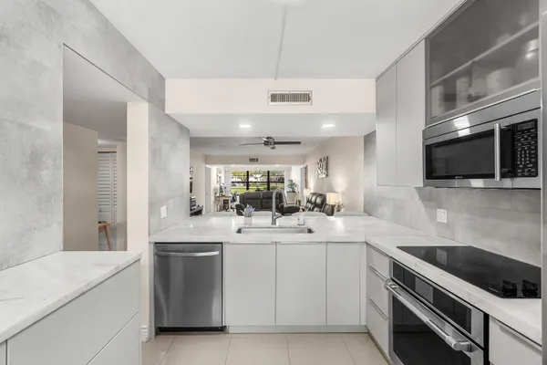 a kitchen with a sink stainless steel appliances and cabinets
