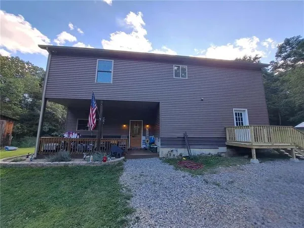 a view of a house with a yard porch and sitting area