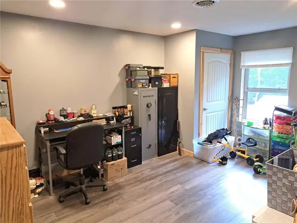 a view of a workspace with furniture and a window