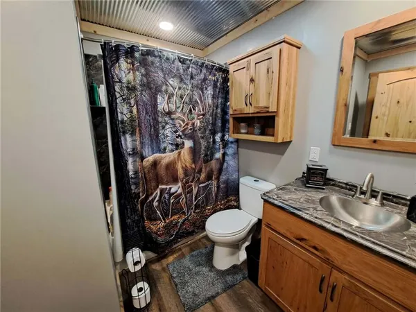 a bathroom with a granite countertop sink mirror vanity and toilet
