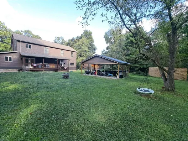 a aerial view of a house with garden and trees