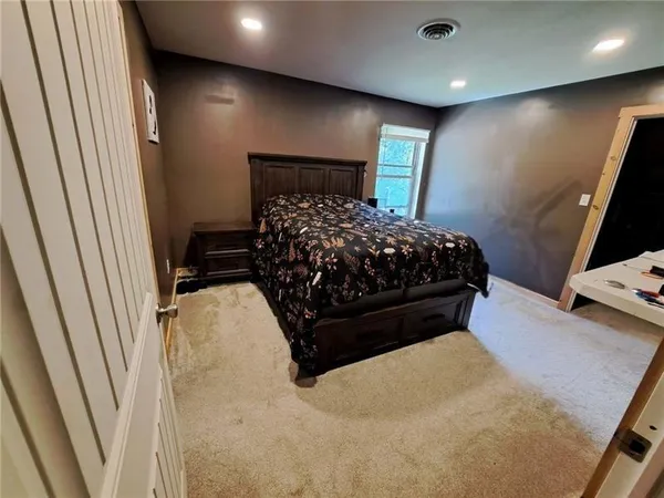 a bed sitting in a bedroom next to a window