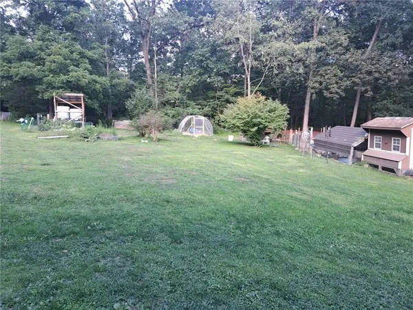 a backyard of a house with table and chairs