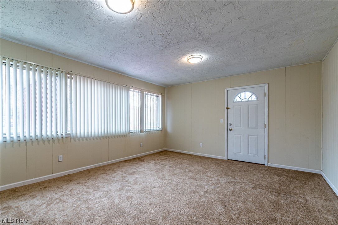 3989 Strandhill Road Cleveland, OH 44128 - Photo 7 of 13 Carpeted entrance foyer with a textured ceiling