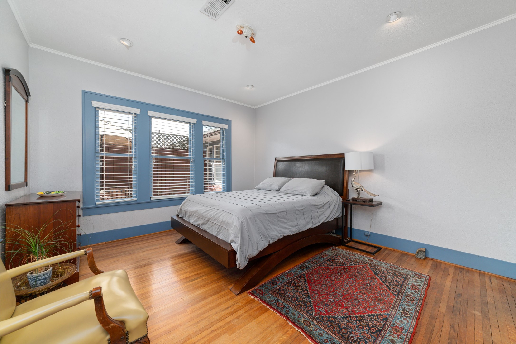 1613 California Street Houston, TX 77006 - Photo 23 of 50 Whether welcoming overnight guests, creating a quiet reading retreat, or designing a beautiful home office, this spacious bedroom adapts effortlessly. Large windows frame views of the private backyard while preserving the calm, relaxed character found throughout the home.