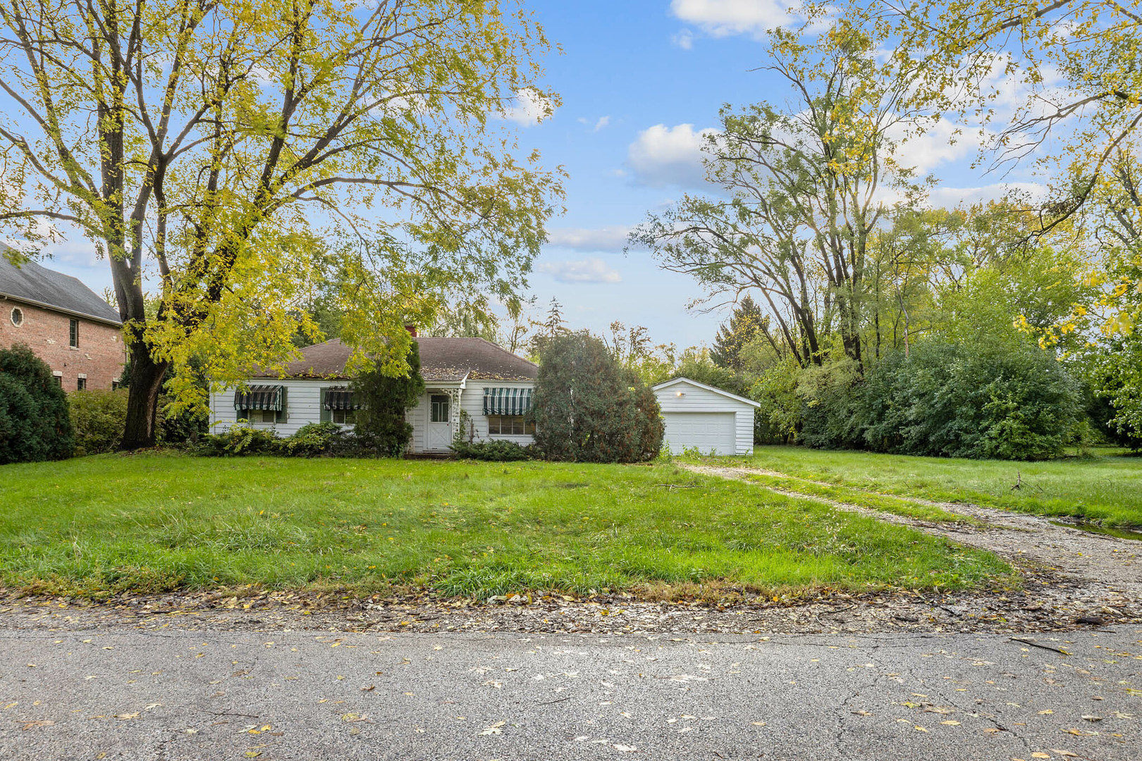 211 Red Oak Road Northbrook, IL 60062 - Photo 1 of 8 a front view of a house with a garden and trees
