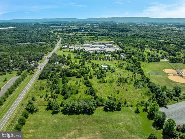 a view of a green field with an ocean view