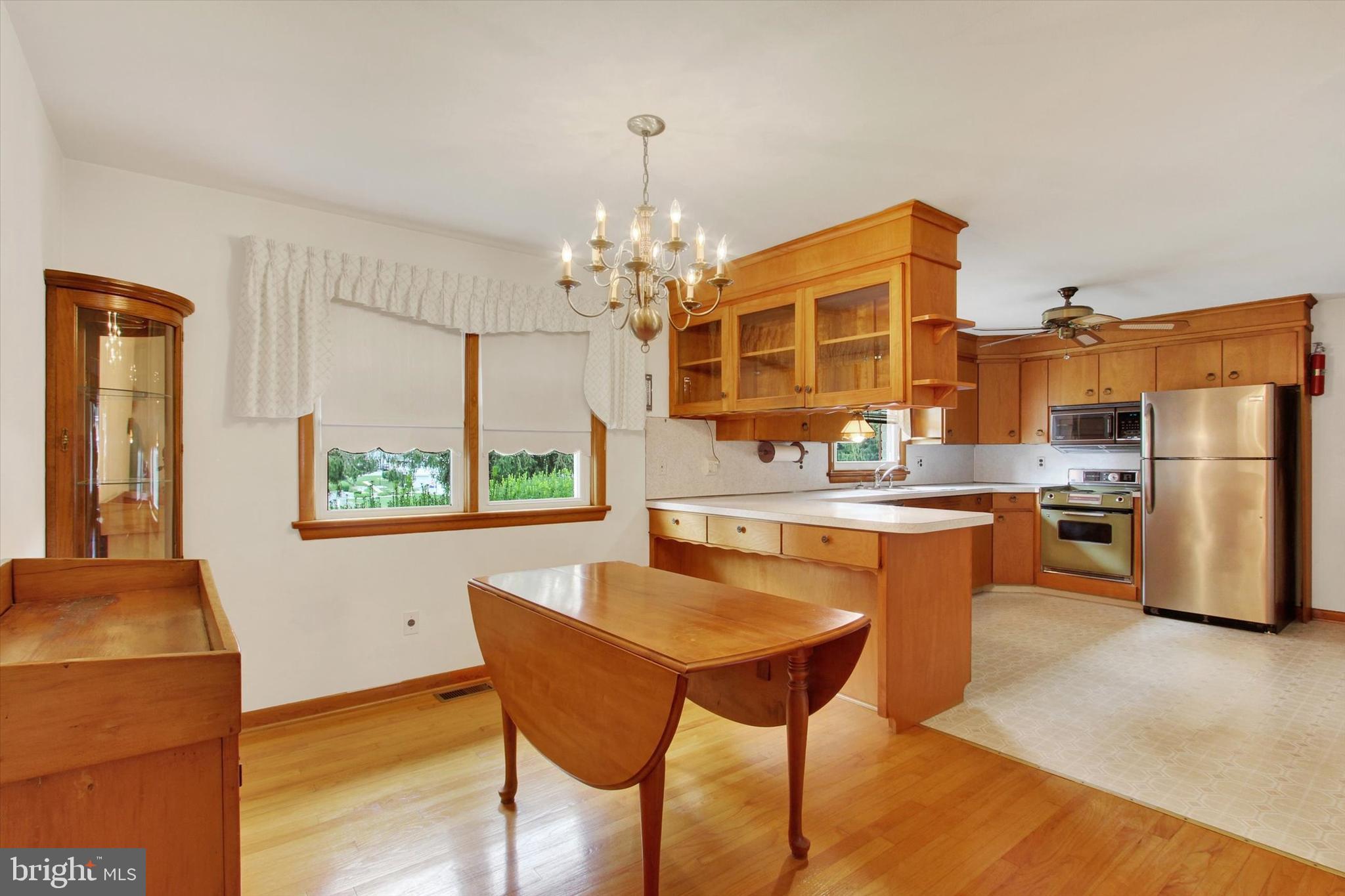 1649 St Paul Street Hampstead, MD 21074 - Photo 7 of 26 a kitchen with stainless steel appliances granite countertop a stove refrigerator and a view of living room