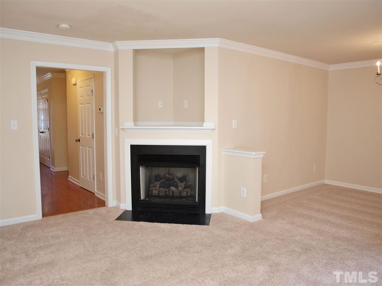 10126 Blackwell Drive Raleigh, NC 27617 - Photo 2 of 14 a living room with a fireplace