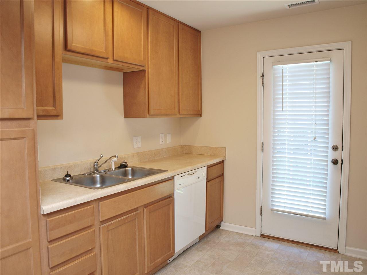 10126 Blackwell Drive Raleigh, NC 27617 - Photo 3 of 14 a kitchen with a sink cabinets and a window