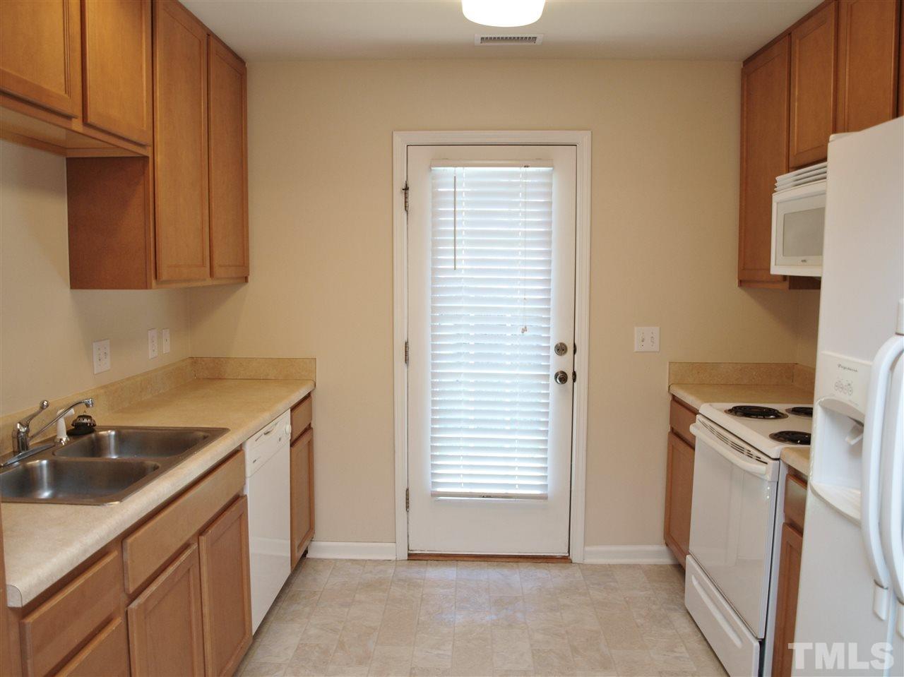 10126 Blackwell Drive Raleigh, NC 27617 - Photo 5 of 14 a kitchen with a sink cabinets and a refrigerator