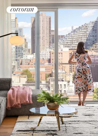 a living room with furniture and a floor to ceiling window