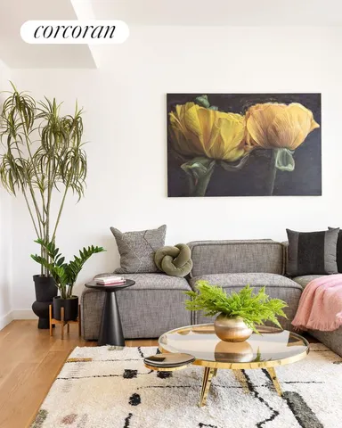 a living room with furniture and a potted plant