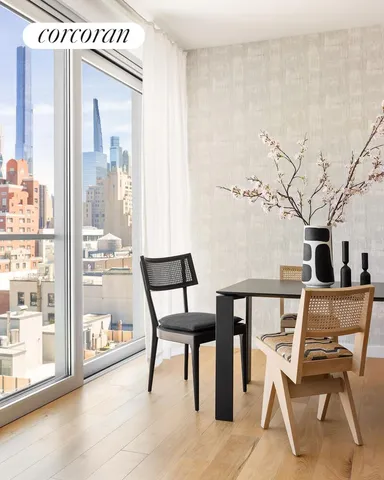 a living room with furniture and a floor to ceiling window