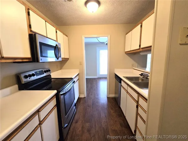 a kitchen with stainless steel appliances granite countertop a stove and a microwave