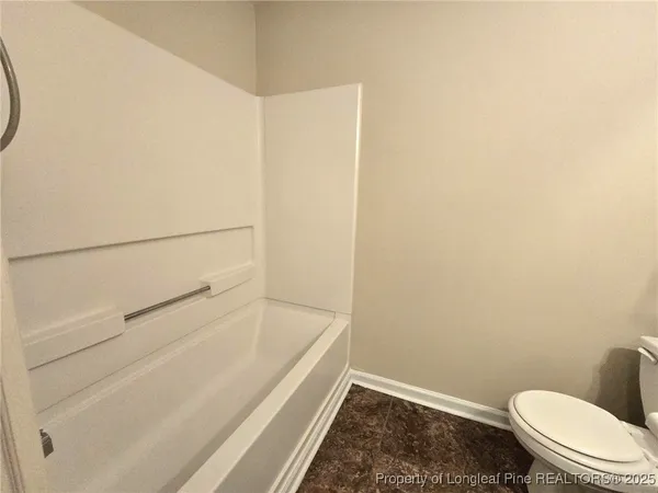 a view of an empty room and wooden floor