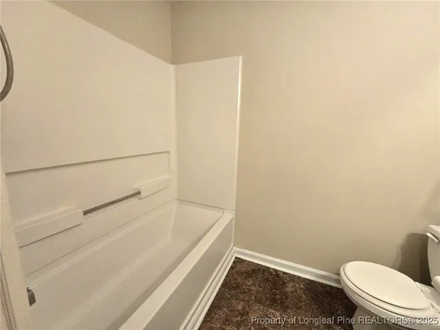 a view of an empty room and wooden floor